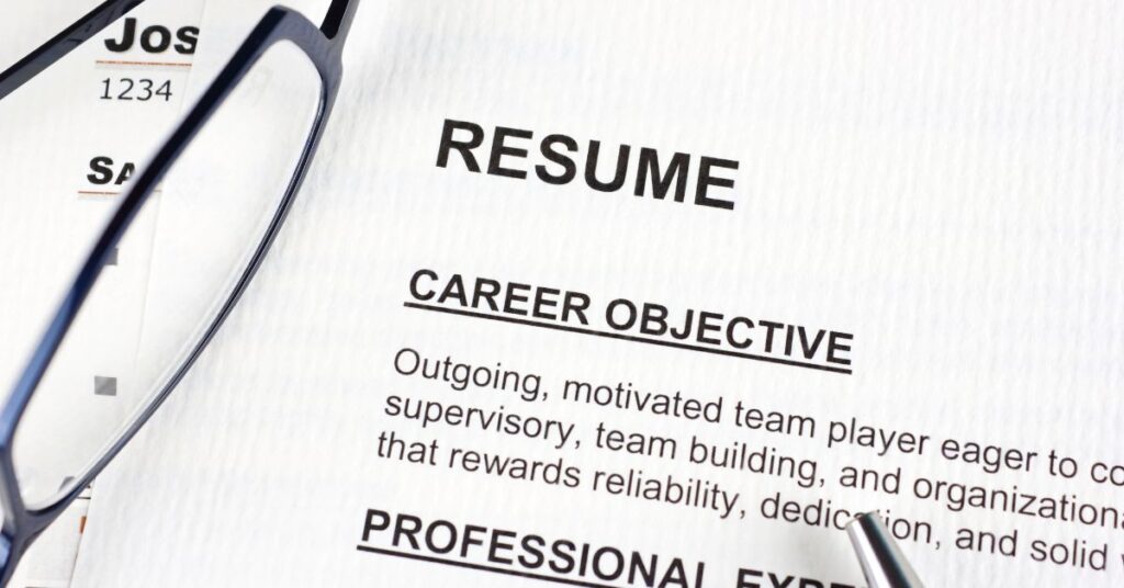 Career Objective is typically for professional resumes and not college application resumes. White paper with black ink, glasses on page, no people, pen
