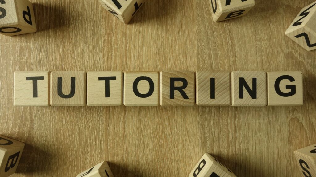Community College Student Support Service: Tutoring. Wood Block letters spelling out tutoring.