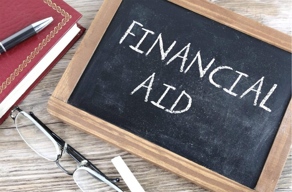 The words financial aid are written on a chalkboard.